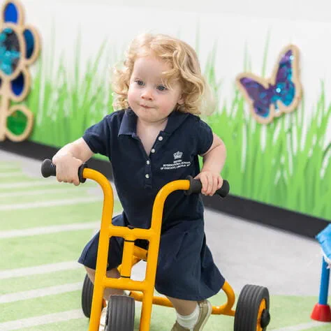 Child ridding bike at BISC Lincoln Park Pre-nursery Chicago