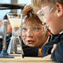 an icon with middle school students during chemistry class
