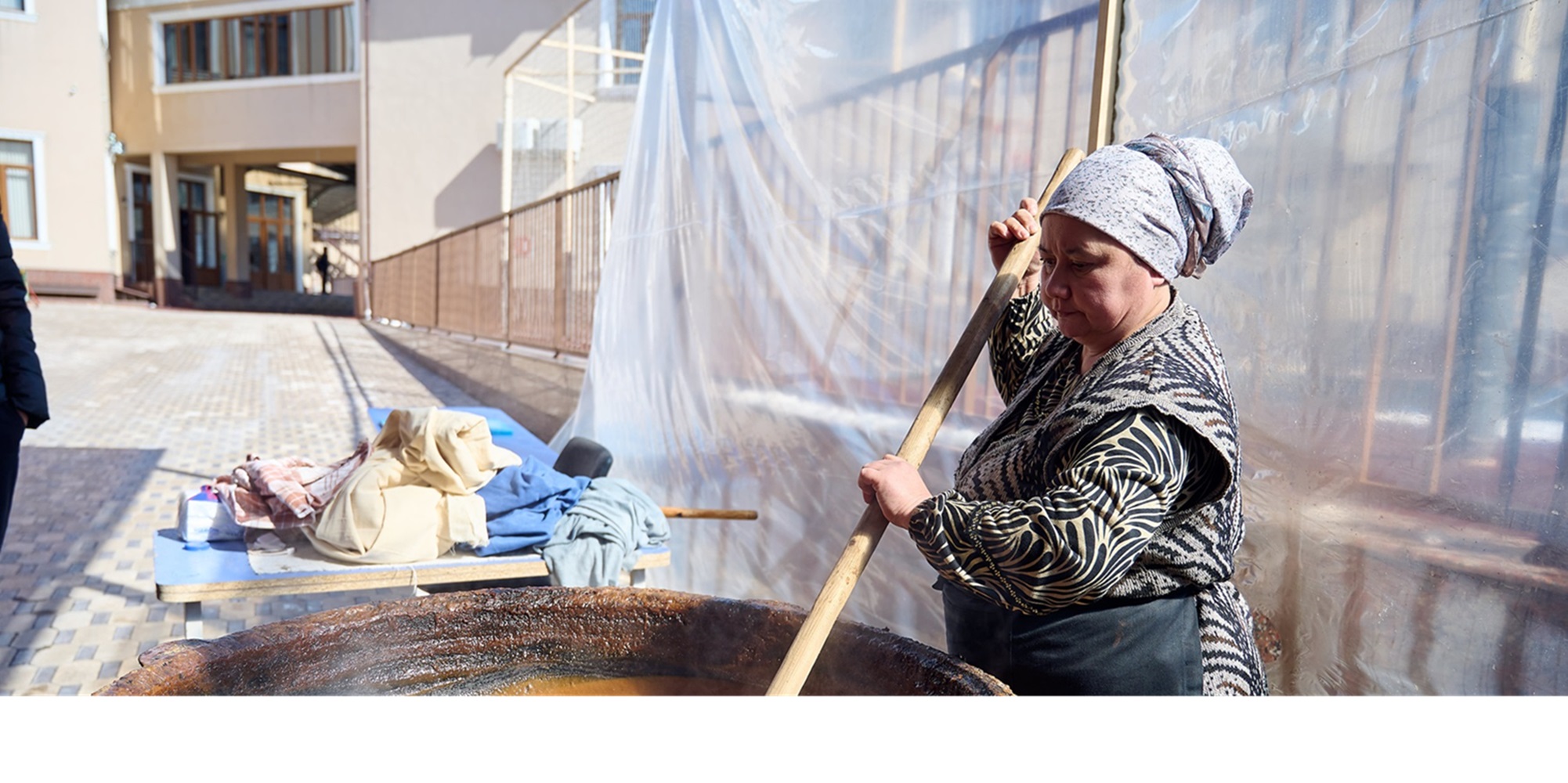 Uzbek woman making traditional sumalak at The British School of Tashkent